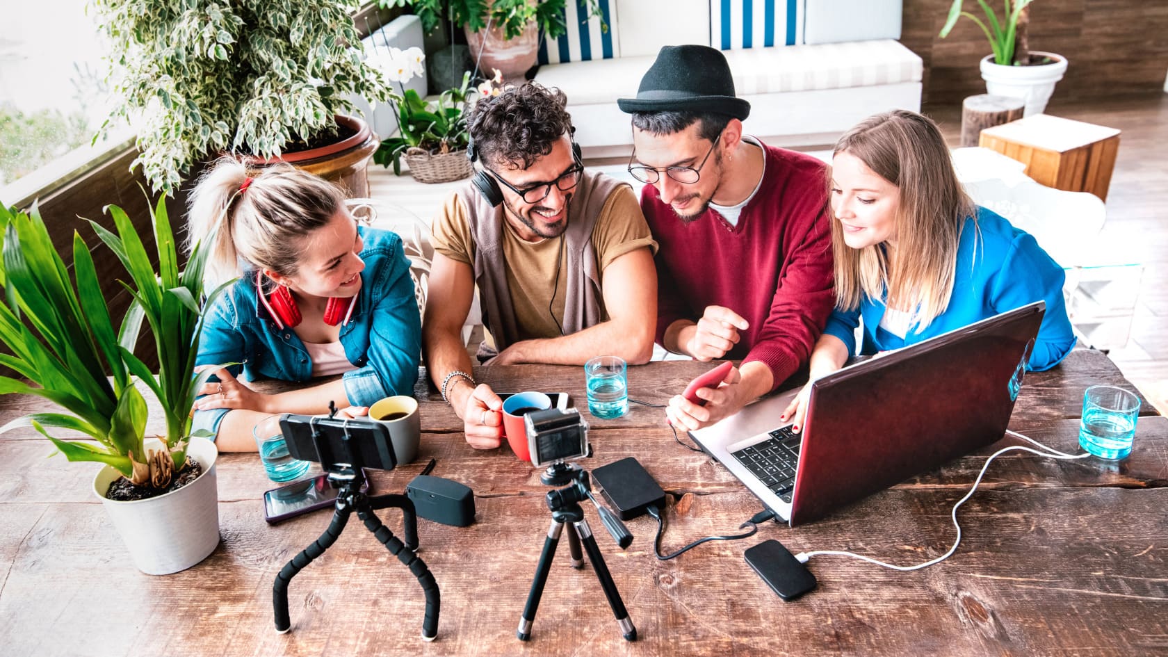 A group of content creator looking at the mobile phone in the living room.e